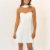 Women's white strapless pleated mini dress with neck scarf.